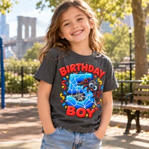 Boy in Birthday Boy Web 5 spider shirt opening presents at a party table