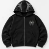 Front flat lay of black Chrome Crawler Hoodie with small chrome spider chest print and silver-gray web details on hood