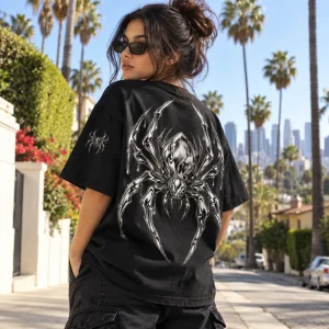 Latina American woman wearing black oversized Chrome Crawler chrome spider shirt in a bright Los Angeles neighborhood