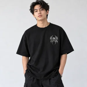 Asian American male model wearing black oversized Chrome Crawler chrome spider shirt from the front