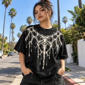 Skater wearing Dripping Web spider web shirt beside a graffiti wall at a skate park