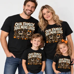 Family wearing black Family Eight Legs matching tees with OUR FAMILY HAS MORE LEGS spider artwork