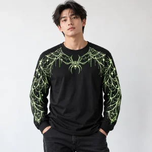 Model wearing black Glow Spider Web Long Sleeve tee with pale green chest spider, web sleeves and small stars
