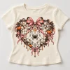 Front flat lay of Cream Baby tee with Halloween Web Heart spider web, orange pumpkin and dusty pink bow design