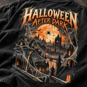 Close-up of Haunted City Web print showing cotton texture, cream spider webs, orange moon and distressed details