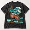 Front flat lay of washed black Haunted Web Motel vintage Halloween spider shirt with turquoise orange and cream artwork