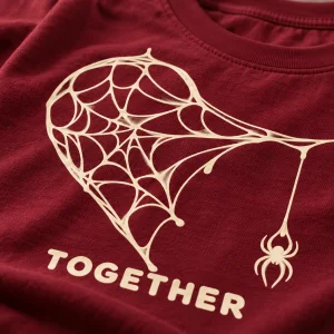 Close-up of cream web heart strands and tiny hanging spider