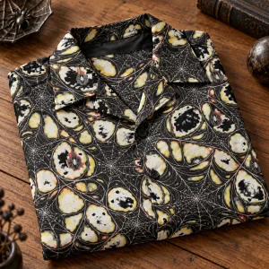 Folded Midnight Orb Repeat black camp collar shirt showing cream asymmetrical orb webs and hidden spider details
