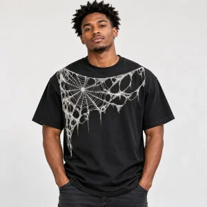 Model wearing black Midnight Orb Web spider web shirt with diagonal shoulder and chest graphic