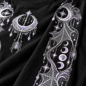 Close-up of Moon Web Arms print showing white and lavender crescent moon, spider, celestial webs, stars, and fabric texture