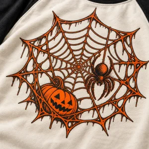 Lifestyle photo of a man wearing Pumpkin Web Raglan halloween spider raglan shirt outdoors on a sunny New York City street