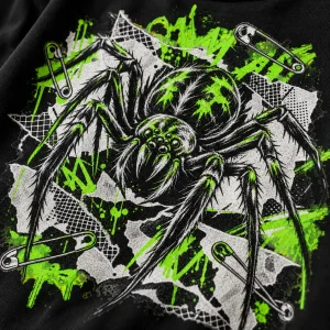 Close-up of hand-inked spider with safety pins and acid-green scribbles