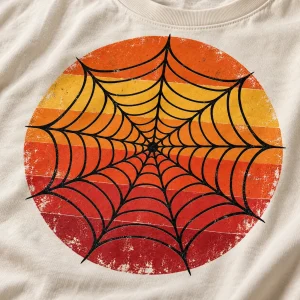 Close-up of Retro Web Sun print showing black spider web lines distressed sunset inks and cream cotton texture