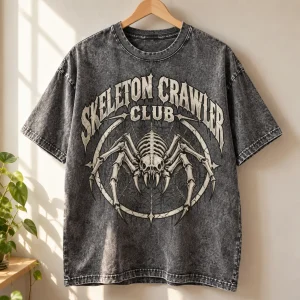Acid-wash gray Skeleton Crawler Club spider skeleton tee displayed on a natural wooden hanger