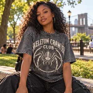 Lifestyle photo of woman wearing acid-wash gray Skeleton Crawler Club vintage skeleton spider shirt outdoors
