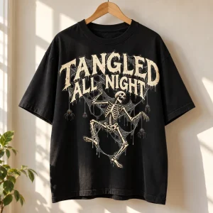 Black oversized skeleton spider shirt on wooden hanger showing TANGLED ALL NIGHT front graphic