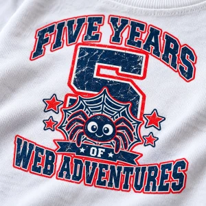 Close-up of Spider Balloon Parade print on white cotton fabric showing cartoon spiders, colorful balloons and large number 5