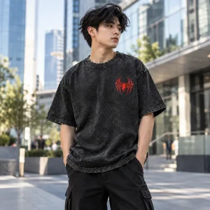 Young man in Spider-Man Acid Wash Back Emblem oversized tee walking down a city street at dusk