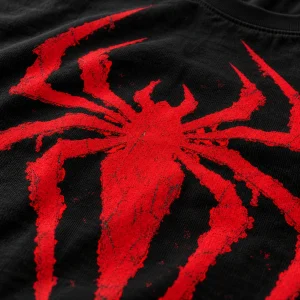 Close-up of the deep red spider emblem with distressed edge texture