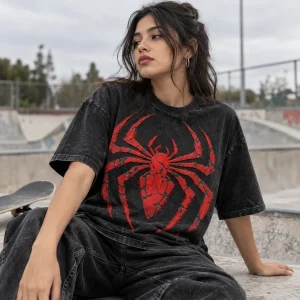 Young man wearing Spider-Man Cracked Emblem tee on a brick rooftop at sunset