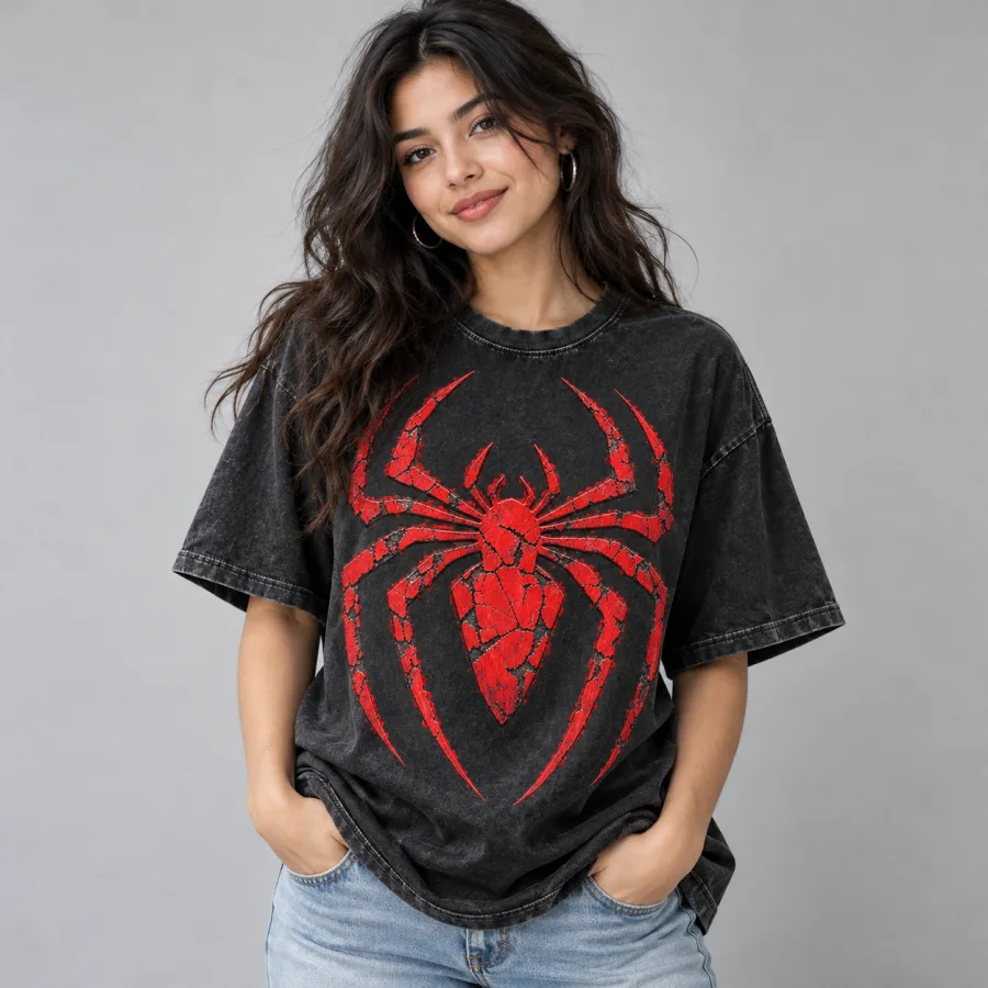 Man wearing washed black Spider-Man Cracked Emblem tee with distressed jeans