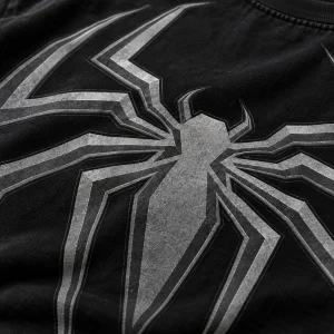Close-up of dark grey tone-on-tone spider emblem on black cotton