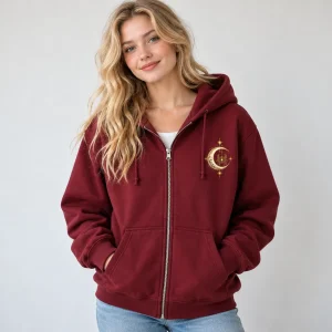 Model wearing burgundy Spider Observatory zip hoodie