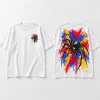 Front flat lay of white oversized Spider Paint Riot tee with small colorful spider paint chest mark