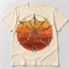 Front flat lay of Sunset Web 1977 vintage spider web shirt in vintage cream with distressed orange mustard and rust sunset graphic