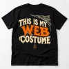 Front flat lay of black funny spider Halloween shirt with This Is My Web Costume cream and orange graphic