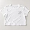 Front flat lay of White Cropped tee with Tiny Web Bow spider web left-chest print