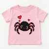 Front flat lay of pale pink Tiny Web Buddy toddler spider shirt with black and red smiling spider and hearts
