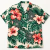 Front flat lay of cream Tropical Web Garden spider Hawaiian shirt with monstera leaves, hibiscus flowers and orb webs