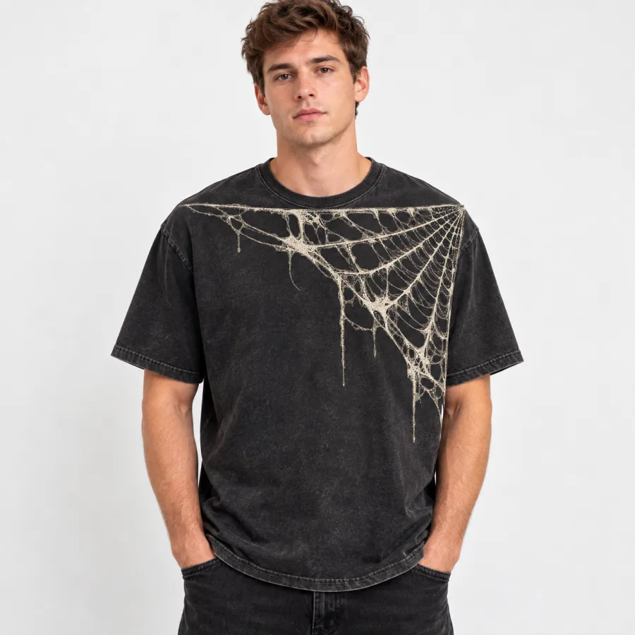Model wearing washed black Vintage Corner Web vintage spider web shirt with faded cream web across the upper chest