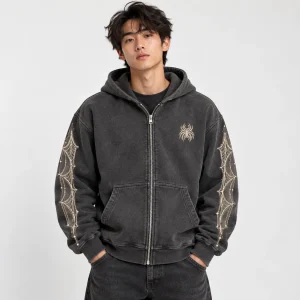 Asian American male model wearing Web Archive Zip washed charcoal spider web zip hoodie from the front