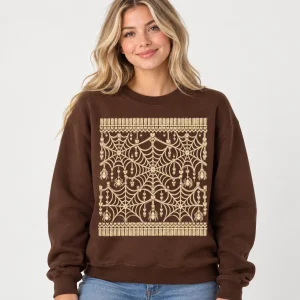 Blonde woman wearing chocolate brown Web Knit Illusion spider web sweater with large cream front graphic