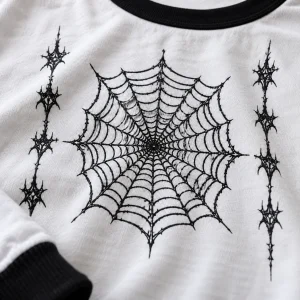Close-up of Webline Ringer black spider web print on white cotton fabric